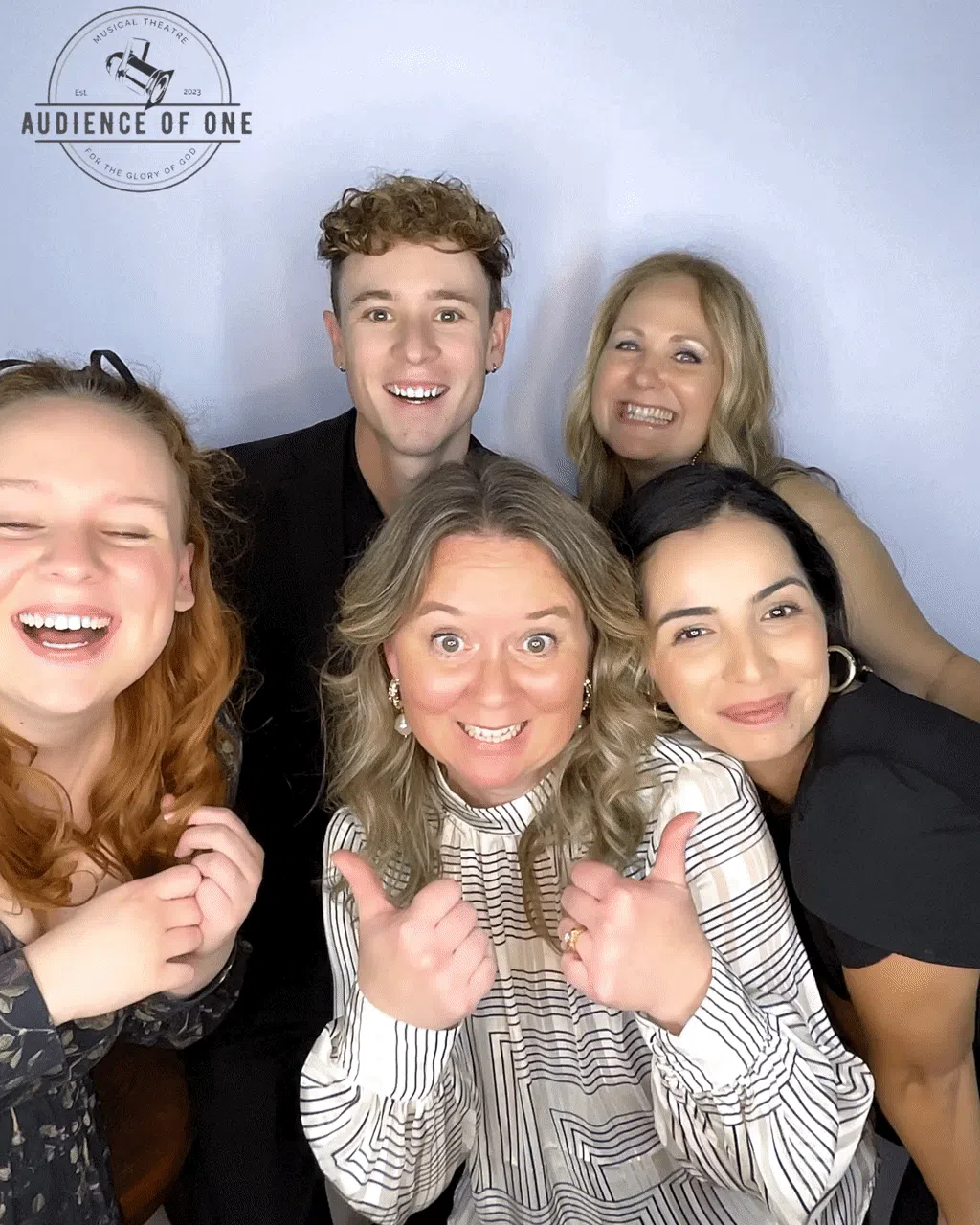 The A1 team laughing together in a photo booth